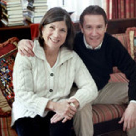 Anna and Gerald sitting on sofa and posing for a picture